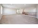 Bright and spacious loft area featuring carpeted floors, abundant natural light, and a staircase railing at 16475 N 183Rd Dr, Surprise, AZ 85388
