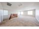 Spacious loft area with carpet flooring, plenty of natural light, and a wooden railing at 16475 N 183Rd Dr, Surprise, AZ 85388