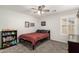 Bedroom featuring a standard bed, gray tones, a ceiling fan, and a white window with shutters at 16565 W Garfield St, Goodyear, AZ 85338