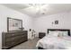 Bedroom featuring a standard bed, colorful tones, a ceiling fan, and a gray dresser with mirror at 16565 W Garfield St, Goodyear, AZ 85338