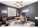 Comfortable bedroom features a ceiling fan, bright windows, and a cozy seating area for relaxation at 16565 W Garfield St, Goodyear, AZ 85338
