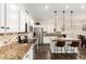 Bright kitchen featuring granite countertops, stainless steel appliances, and a center island with seating at 16565 W Garfield St, Goodyear, AZ 85338
