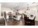 Open-concept kitchen with white cabinetry, granite countertops, stainless steel appliances, and a large center island at 16565 W Garfield St, Goodyear, AZ 85338