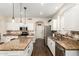 Spacious kitchen with granite countertops, stainless steel appliances, and white cabinetry at 16565 W Garfield St, Goodyear, AZ 85338