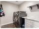 Functional laundry room boasts modern washer and dryer units, with ample counter space and storage at 16565 W Garfield St, Goodyear, AZ 85338