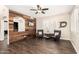 Inviting living room with hardwood floors, accent wall, plantation shutters, and contemporary furnishings at 16565 W Garfield St, Goodyear, AZ 85338