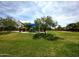 Community park with lush green space, playground, gazebo, and mature shade trees for recreational enjoyment at 16565 W Garfield St, Goodyear, AZ 85338