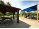 Picnic pavilion and playground with vibrant blue shade structure at 16565 W Garfield St, Goodyear, AZ 85338