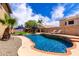 Stunning backyard pool with lounge chairs, umbrellas, and lush green lawn, perfect for relaxation and entertainment at 16565 W Garfield St, Goodyear, AZ 85338