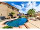 Beautiful backyard pool with lounge chairs, umbrellas, lush green lawn, and a spacious patio, creating an outdoor oasis at 16565 W Garfield St, Goodyear, AZ 85338