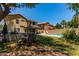 Spacious backyard with a sparkling pool, covered patio, and manicured lawn at 1723 W Mercury Way, Chandler, AZ 85224