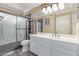 Neutral bathroom featuring a white sink, shower, toilet, mirror, and tile floor at 1723 W Mercury Way, Chandler, AZ 85224