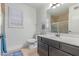 Bathroom features a window with shutters, tile floor, vanity with sink, toilet and tub at 1723 W Mercury Way, Chandler, AZ 85224
