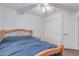 Clean bedroom with a wood bed frame, nightstand, window, and ceiling fan at 1723 W Mercury Way, Chandler, AZ 85224