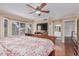 Spacious main bedroom featuring hardwood floors, ceiling fan, and a decorative wood bed frame at 1723 W Mercury Way, Chandler, AZ 85224