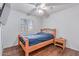 Clean bedroom with a wood bed frame, nightstand, window, and ceiling fan at 1723 W Mercury Way, Chandler, AZ 85224