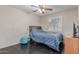 Bedroom with dark wood floor, tan walls, window with shutters, ceiling fan and furnished with bed at 1723 W Mercury Way, Chandler, AZ 85224