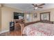 Spacious main bedroom featuring hardwood floors, ceiling fan, and a decorative wood bed frame at 1723 W Mercury Way, Chandler, AZ 85224