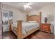 Bedroom with wood floors, neutral paint, window with shutters, bed and matching end table with lamp at 1723 W Mercury Way, Chandler, AZ 85224