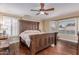 Spacious main bedroom featuring hardwood floors, ceiling fan, and a decorative wood bed frame at 1723 W Mercury Way, Chandler, AZ 85224