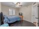 Bedroom with window with shutters, ceiling fan, wood floors, bed, and neutral paint at 1723 W Mercury Way, Chandler, AZ 85224
