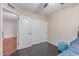 Bedroom features a ceiling fan, wood floor, closet, window with shutters, and neutral paint at 1723 W Mercury Way, Chandler, AZ 85224