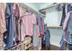 Walk-in closet with hardwood floors and filled with a variety of clothing at 1723 W Mercury Way, Chandler, AZ 85224