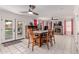 Dining area featuring tile floors, backyard views through French doors, and adjacent to a living area with fireplace at 1723 W Mercury Way, Chandler, AZ 85224