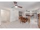 Open dining area with neutral color palette and tile floors, complete with contemporary light fixture and staircase access at 1723 W Mercury Way, Chandler, AZ 85224