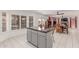 Open kitchen with a central island, stainless appliances, and seamless integration with the dining and living spaces at 1723 W Mercury Way, Chandler, AZ 85224