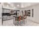 Kitchen boasts an island with bar seating, stainless steel appliances, and ample natural light from large windows at 1723 W Mercury Way, Chandler, AZ 85224