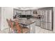 Bright kitchen with granite countertops, stainless steel appliances, and an island with bar seating for casual dining at 1723 W Mercury Way, Chandler, AZ 85224