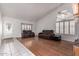 Spacious living room with hardwood flooring, plantation shutters, and abundant natural light at 1723 W Mercury Way, Chandler, AZ 85224
