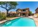 Backyard oasis featuring a sparkling pool, lush greenery, and inviting patio area at 1723 W Mercury Way, Chandler, AZ 85224