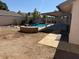 Back yard with an in-ground pool, covered patio, planter box, and construction in progress at 17371 N 86Th Ave, Peoria, AZ 85382