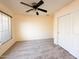 Bedroom with neutral carpet, ceiling fan, closet, and light paint at 17371 N 86Th Ave, Peoria, AZ 85382