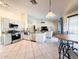 Open kitchen floor plan with stone countertops, stainless appliances, an island and view of the living room at 17371 N 86Th Ave, Peoria, AZ 85382