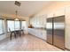 Bright kitchen featuring stainless steel appliances, granite countertops, a table, and tiled floors at 17371 N 86Th Ave, Peoria, AZ 85382