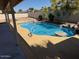 Backyard pool featuring in-pool seating, rock features and plenty of concrete decking at 17371 N 86Th Ave, Peoria, AZ 85382