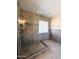 Modern shower with tile walls, glass door, and a rain shower head at 17371 N 86Th Ave, Peoria, AZ 85382