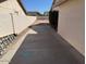 Narrow side yard with concrete and block fence. Some construction materials seen at 17371 N 86Th Ave, Peoria, AZ 85382