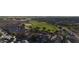 An aerial view of a community park featuring tennis courts and plenty of green space for activities at 17851 N Mughetto Dr, Maricopa, AZ 85138