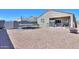 Enclosed backyard features a trampoline, covered patio, and a fire pit at 17851 N Mughetto Dr, Maricopa, AZ 85138