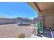 Backyard with trampoline, hardscaped landscaping, patio cover, and privacy fence at 17851 N Mughetto Dr, Maricopa, AZ 85138