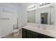Bright bathroom featuring a neutral vanity, white toilet, and a well-lit mirror at 17851 N Mughetto Dr, Maricopa, AZ 85138