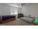Bedroom featuring carpet and ceiling fan, furnished with two beds and a crib for flexible arrangements at 17851 N Mughetto Dr, Maricopa, AZ 85138
