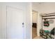 Welcoming entryway with a white front door, a coat rack, and a glimpse into an adjacent room at 17851 N Mughetto Dr, Maricopa, AZ 85138