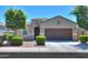 Charming single-story home with well-manicured landscaping, a two-car garage, and inviting curb appeal at 17851 N Mughetto Dr, Maricopa, AZ 85138