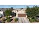 This home showcases a well-maintained front yard with lush landscaping and a charming entrance, enhancing curb appeal at 17851 N Mughetto Dr, Maricopa, AZ 85138