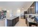 This kitchen features granite countertops, stainless steel appliances, and dark cabinets, adding sophistication to the space at 17851 N Mughetto Dr, Maricopa, AZ 85138